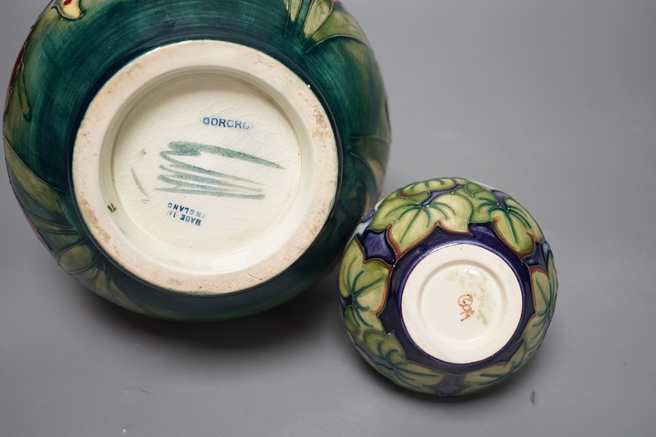 A Moorcroft orchid pattern vase and another smaller vase, orchid vase 19cms high